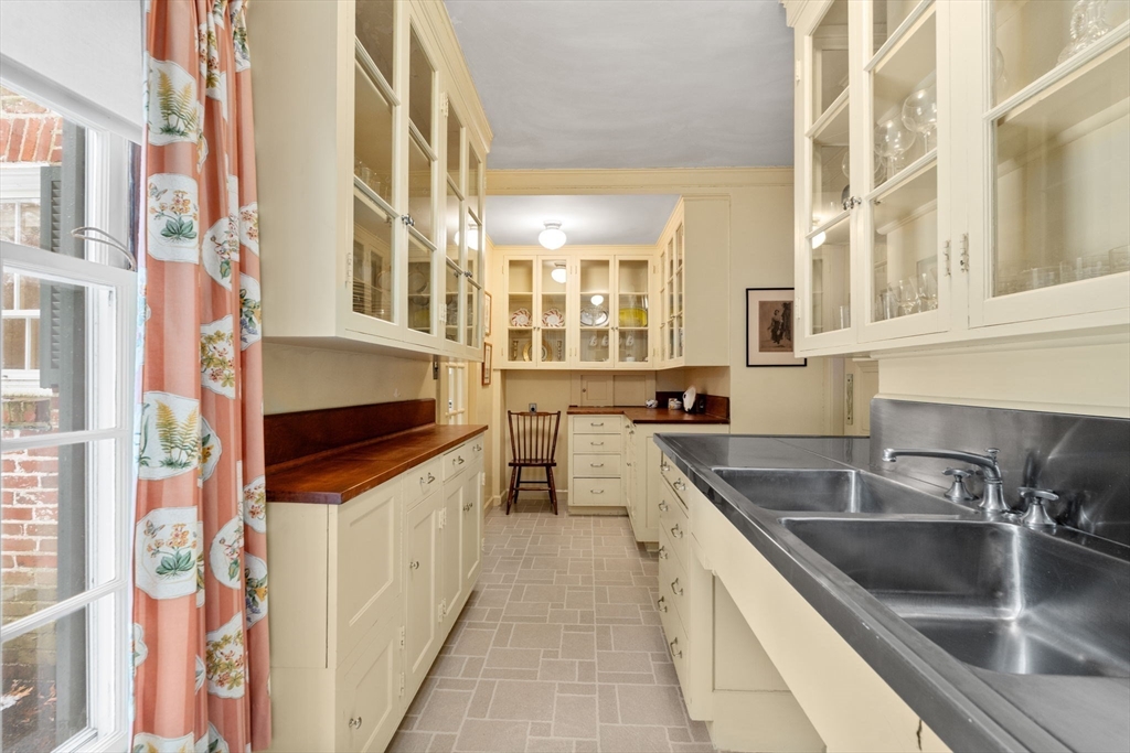 27 Laurel Road Chestnut Hill, MA 02467 - Photo 8 of 20 a kitchen with stainless steel appliances granite countertop a sink and dishwasher a stove a oven with wooden cabinets