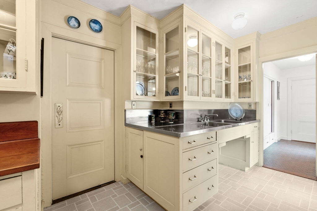 27 Laurel Road Chestnut Hill, MA 02467 - Photo 9 of 20 a kitchen with stainless steel appliances a cabinets and a window