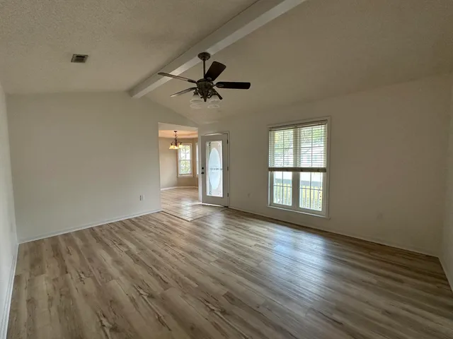 wooden floor in an empty room with a window