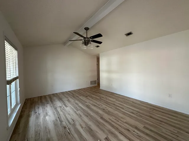 a kitchen with stainless steel appliances granite countertop a refrigerator sink and stove