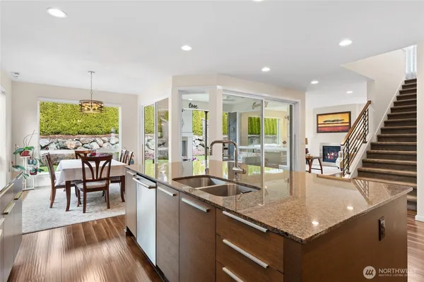 a kitchen with large windows and refrigerator