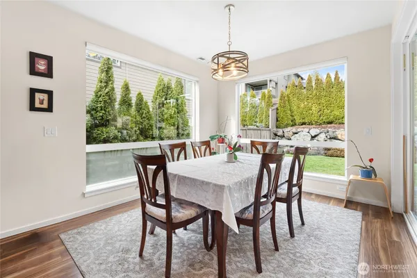 a view of a dining room with furniture a chandelier and wooden floor