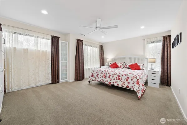 a bedroom with bed and a large window