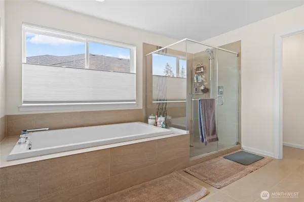 a spacious bathroom with a bathtub and a shower