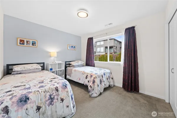 a bedroom with two beds and a window