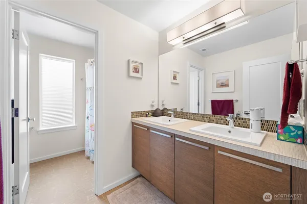 a bathroom with a double vanity sink mirror and