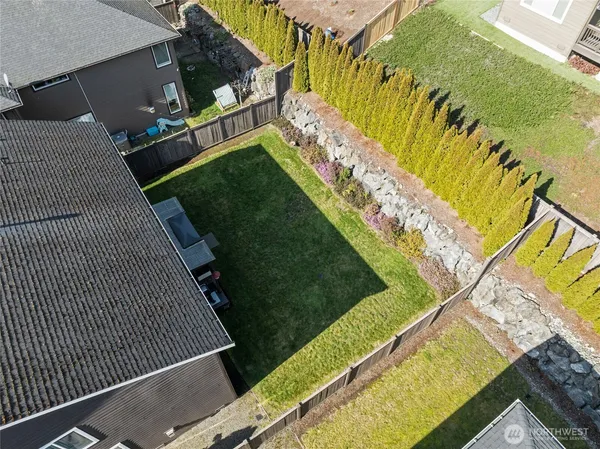 an aerial view of a residential houses with yard