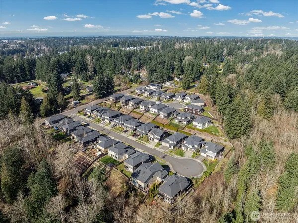 an aerial view of a house with a yard and lake view