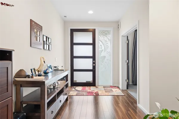 a view of a workspace with wooden floor and furniture