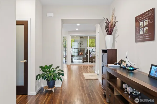 a living room with furniture and potted plant