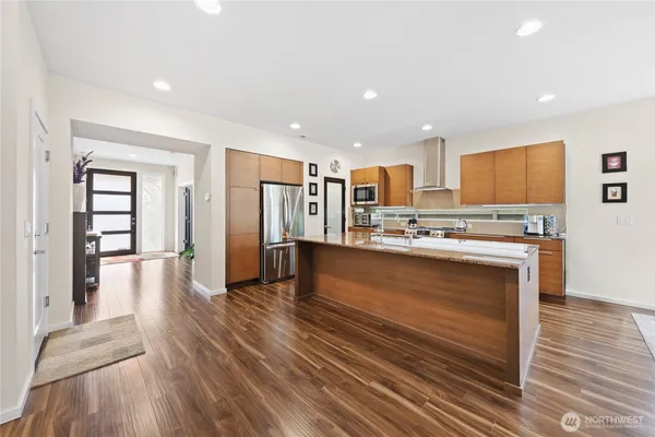 a view of kitchen with refrigerator microwave and wooden floor