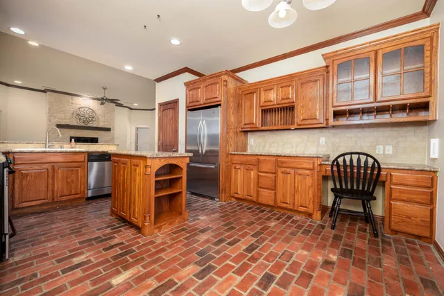 a kitchen with cabinets and chairs