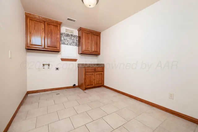 a view of kitchen with cabinets