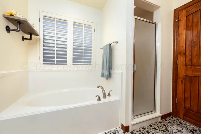 a bathroom with a bathtub and a shower