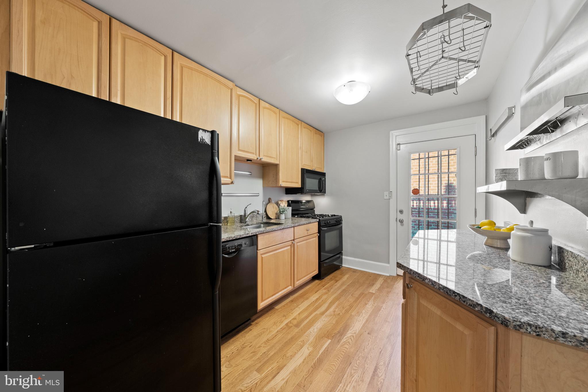 718 13th Street Northeast Washington, DC 20002 - Photo 11 of 35 a kitchen with granite countertop stainless steel appliances a refrigerator a sink a stove cabinets and a dining table