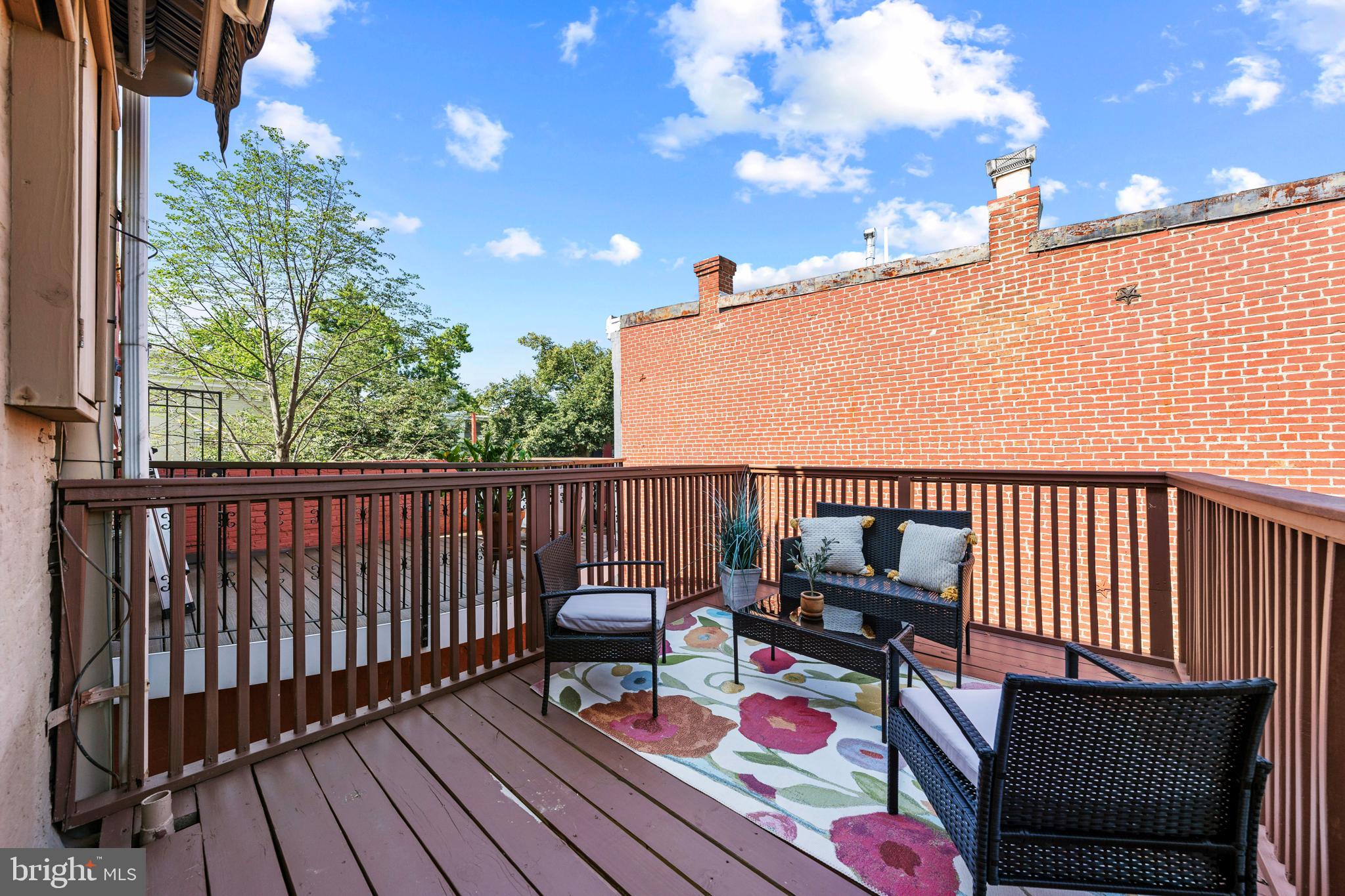 718 13th Street Northeast Washington, DC 20002 - Photo 33 of 35 a balcony with wooden benches and floor