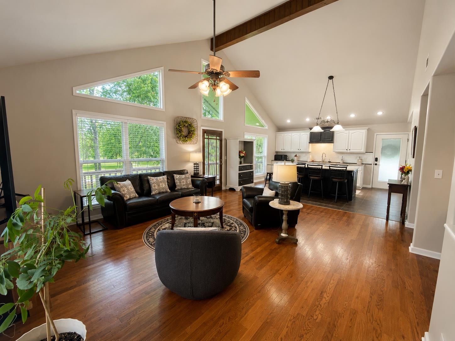 620 Old Road Counce, TN 38326 - Photo 6 of 21 Expansive living area featuring vaulted ceilings with exposed beam, wood-finish flooring, and a ceiling fan