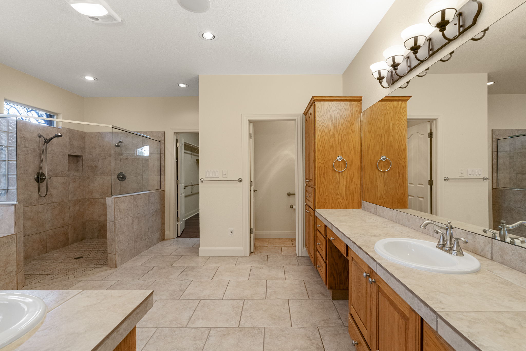 301 Goldridge Drive Georgetown, TX 78633 - Photo 19 of 40 a spacious bathroom with a double vanity sink mirror and shower