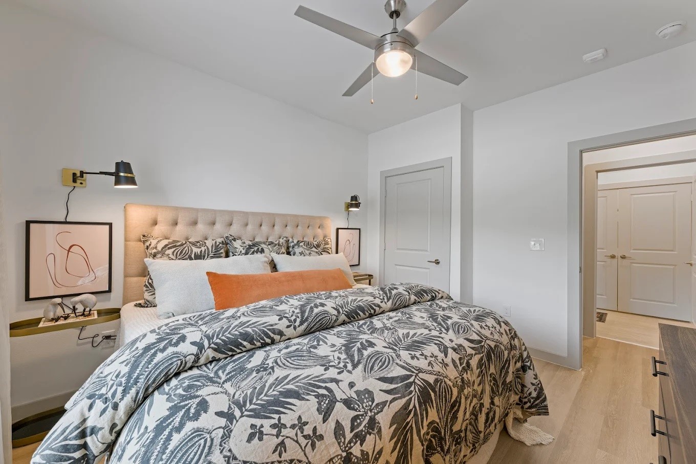 1888 Brittmoore Road, Unit 1220 Houston, TX 77043 - Photo 5 of 16 a bedroom with a large bed and a chandelier