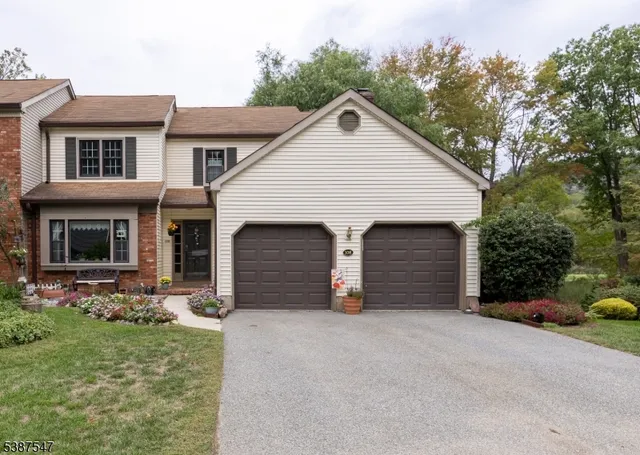 a view of a house with a yard and garage