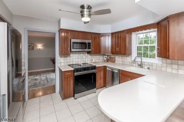 a kitchen with stainless steel appliances granite countertop a sink and a stove top oven