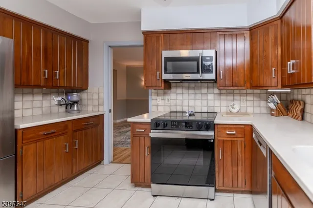 a kitchen with a sink stove and microwave