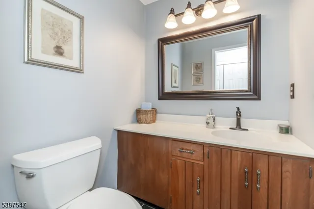a bathroom with a toilet a sink and mirror
