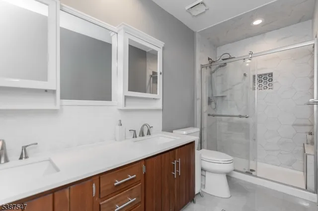 a bathroom with a sink toilet and shower