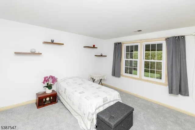 a bedroom with a bed and a dresser in it