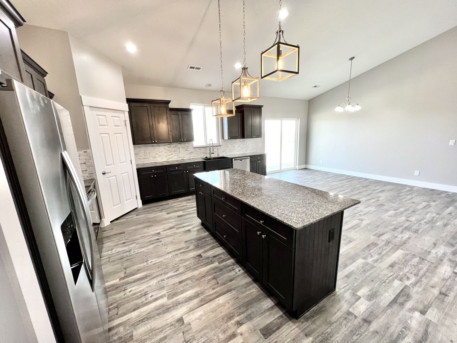 1151 Sun Vly Road Spring Creek, NV 89815 - Photo 11 of 30 a kitchen with a stove and a refrigerator