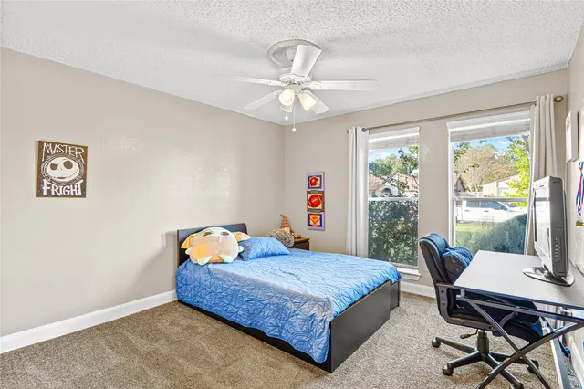 a bathroom with a granite countertop sink a toilet and a mirror