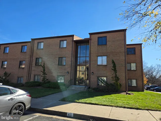 a car parked in front of a brick house