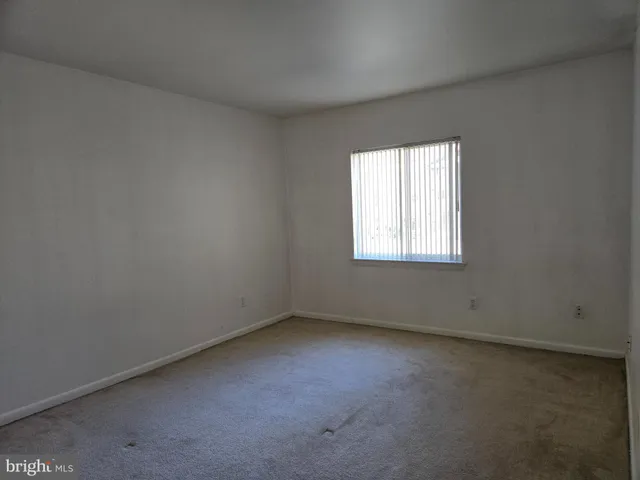 a view of an empty room and closet area