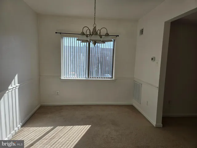 a view of empty room with stairs