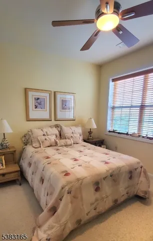 a bedroom with a bed and a lamp