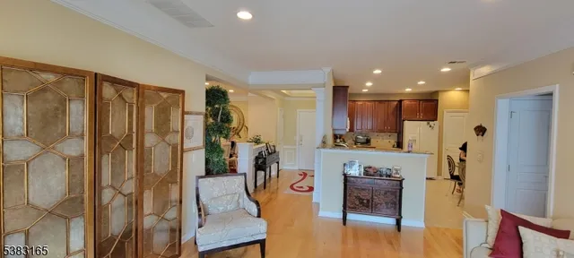 a view of kitchen with stainless steel appliances granite countertop a refrigerator and cabinets