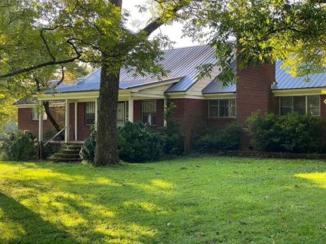 1795 Wilson Road Memphis, TN 38116 - Photo 1 of 1 a view of a house with a yard plants and a large tree