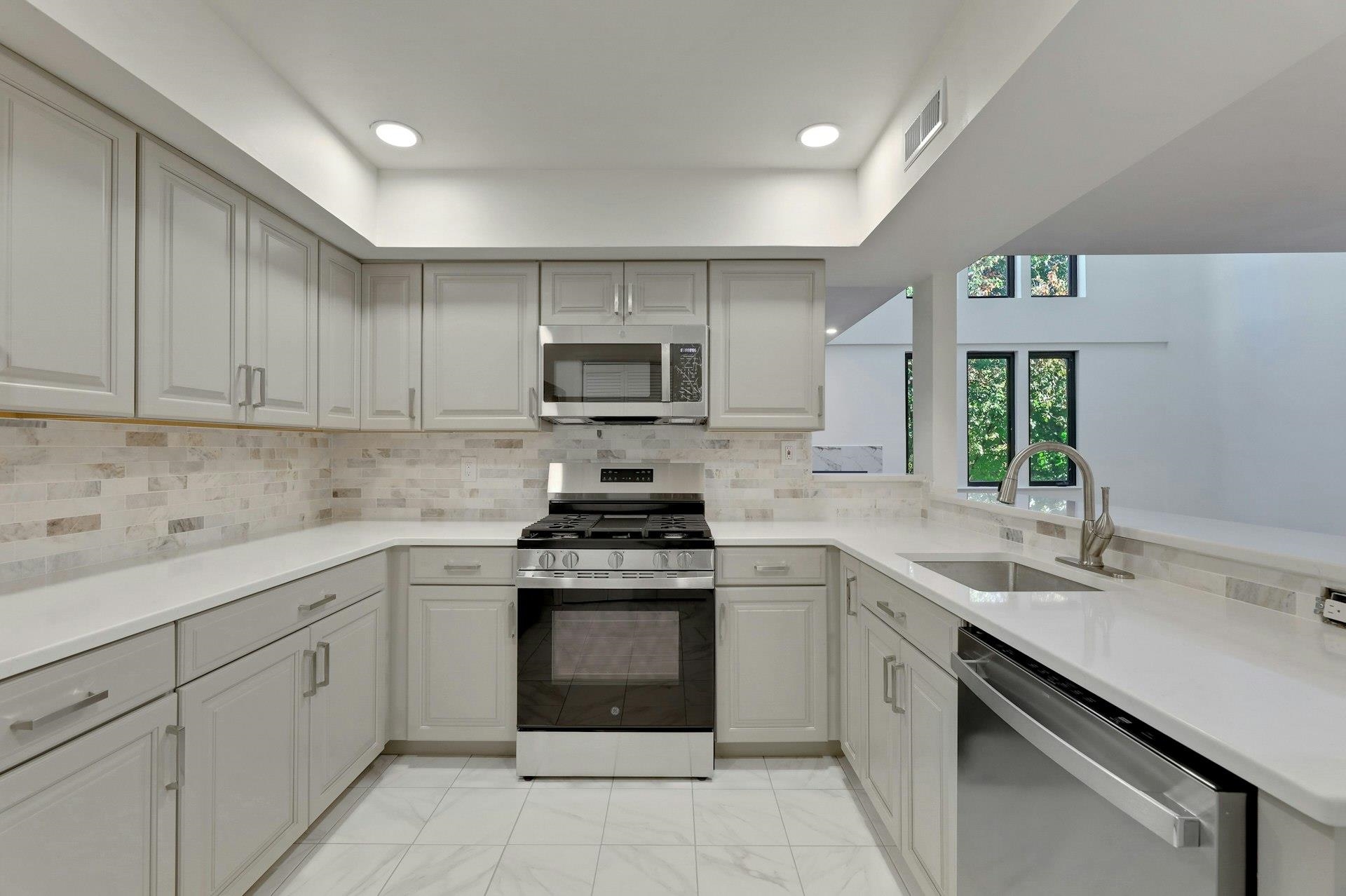 726 Mainsail Lane, Unit MAINSAIL LANE Secaucus, NJ 07094 - Photo 16 of 39 a kitchen with cabinets appliances a sink and a counter top space