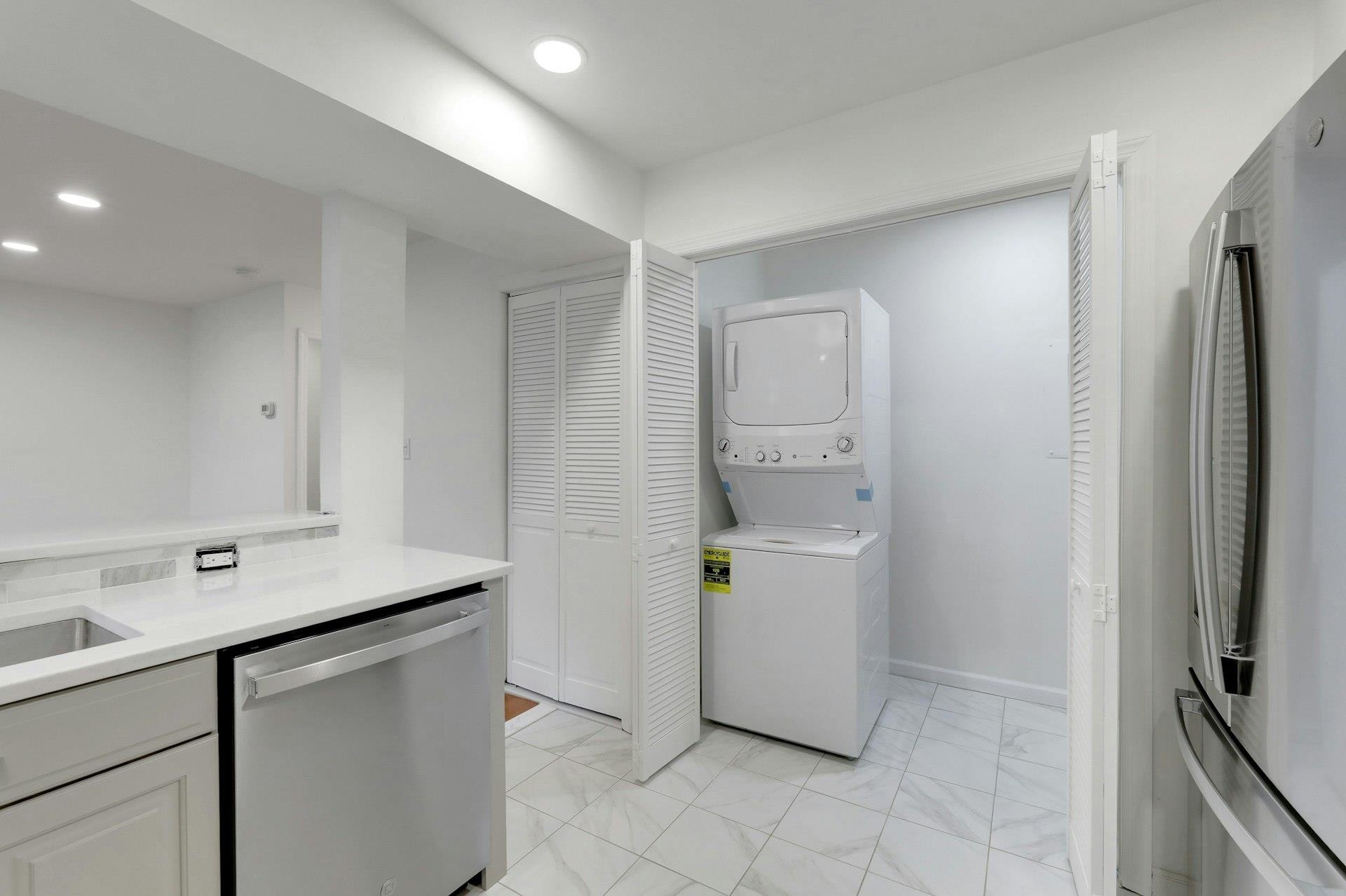 726 Mainsail Lane, Unit MAINSAIL LANE Secaucus, NJ 07094 - Photo 18 of 39 a utility room with cabinets washer and dryer