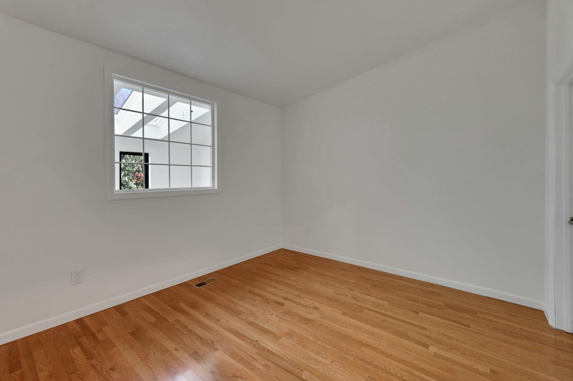 726 Mainsail Lane, Unit MAINSAIL LANE Secaucus, NJ 07094 - Photo 23 of 39 an empty room with wooden floor and windows