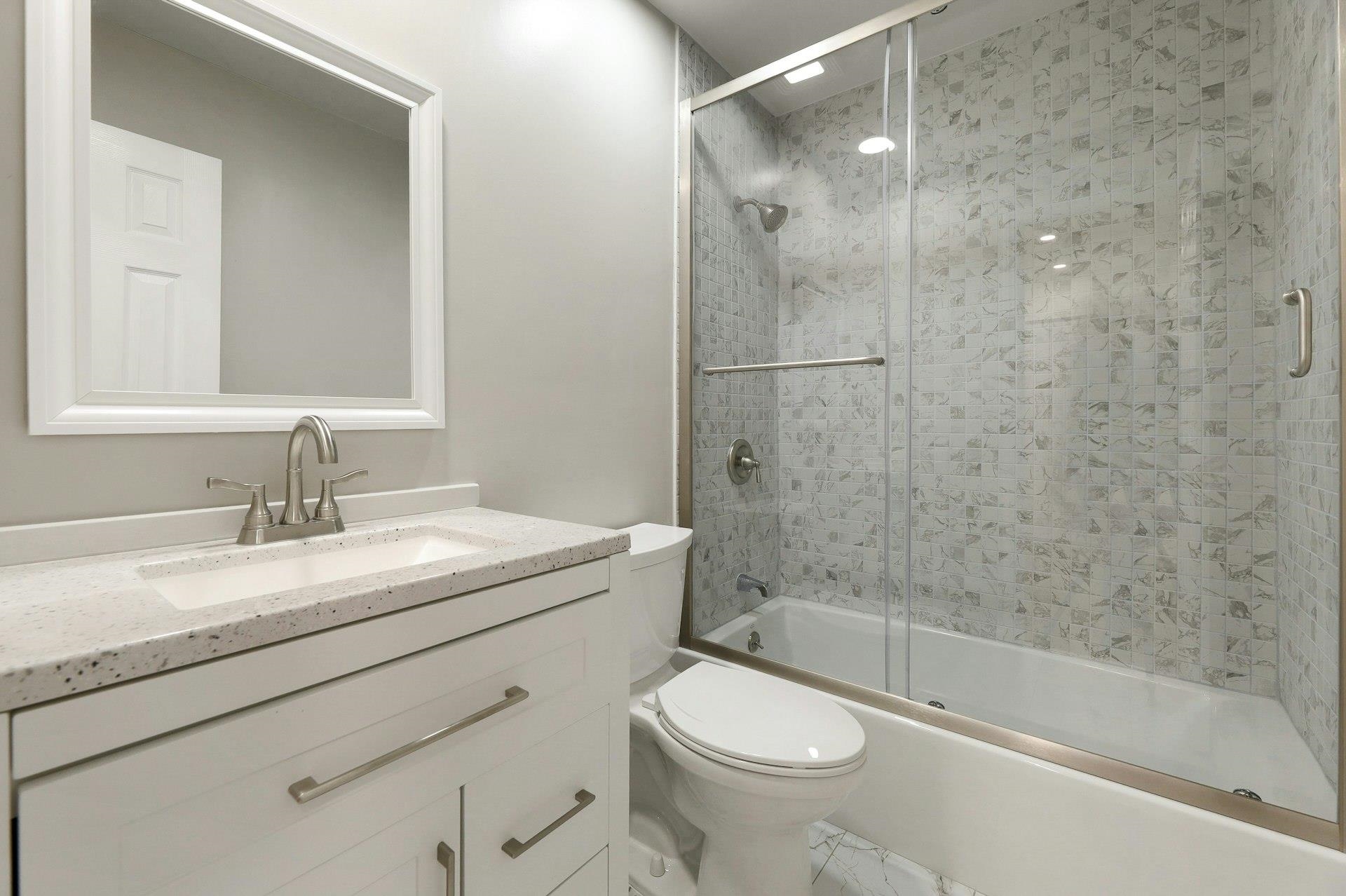 726 Mainsail Lane, Unit MAINSAIL LANE Secaucus, NJ 07094 - Photo 27 of 39 a bathroom with a granite countertop sink a toilet and shower
