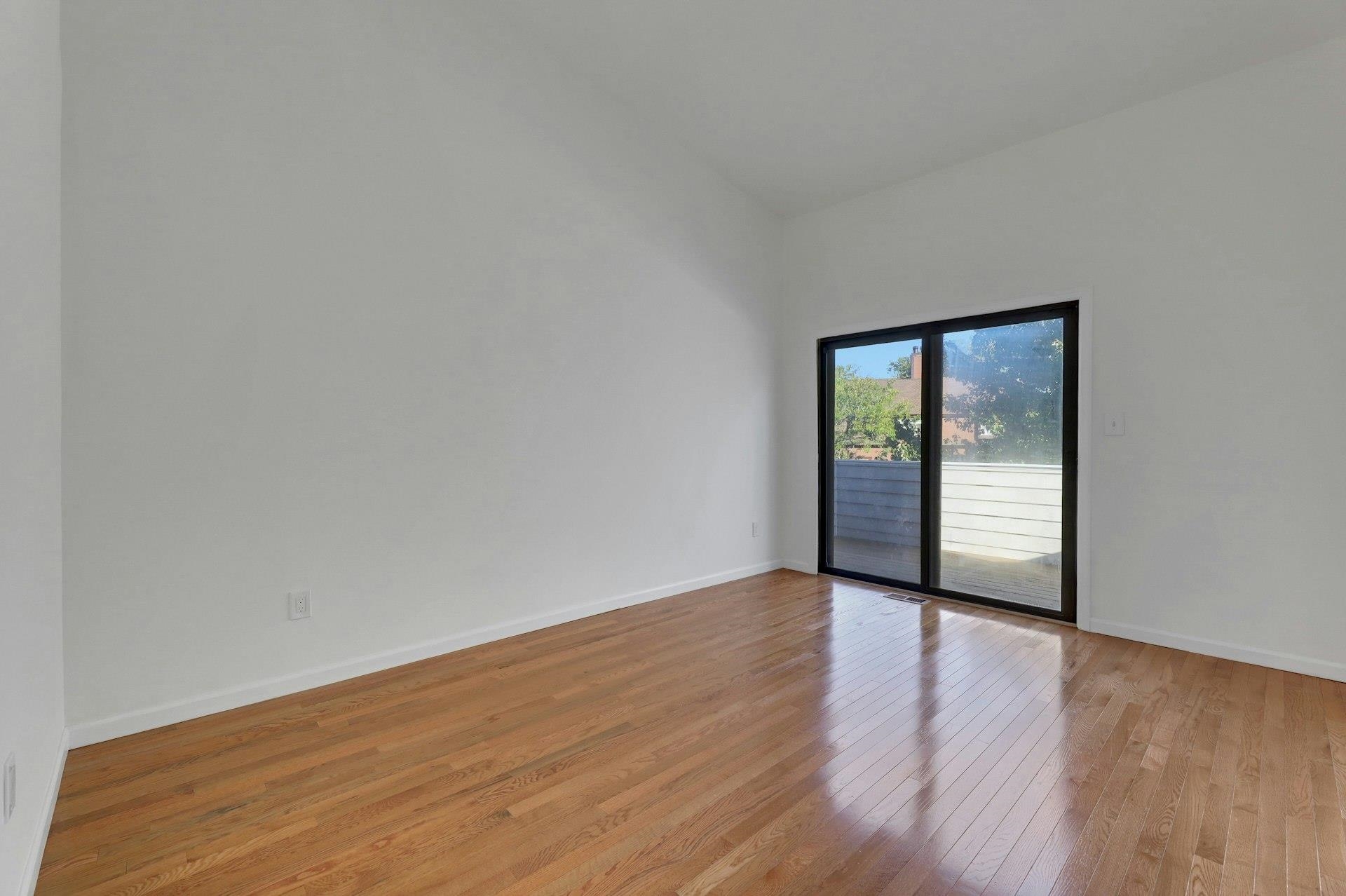 726 Mainsail Lane, Unit MAINSAIL LANE Secaucus, NJ 07094 - Photo 29 of 39 a view of an empty room with wooden floor and a window