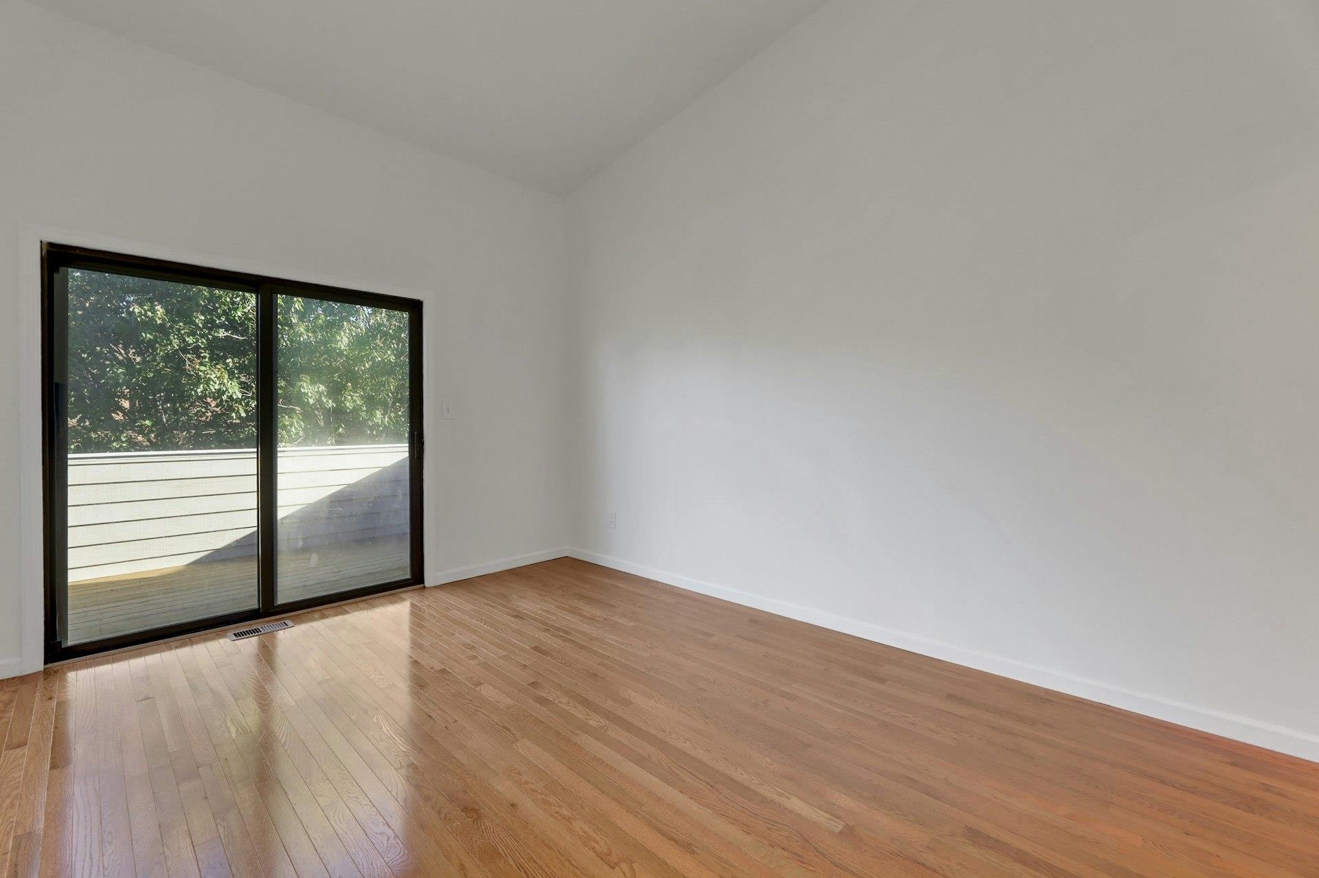 726 Mainsail Lane, Unit MAINSAIL LANE Secaucus, NJ 07094 - Photo 30 of 39 a view of an empty room with wooden floor and a window