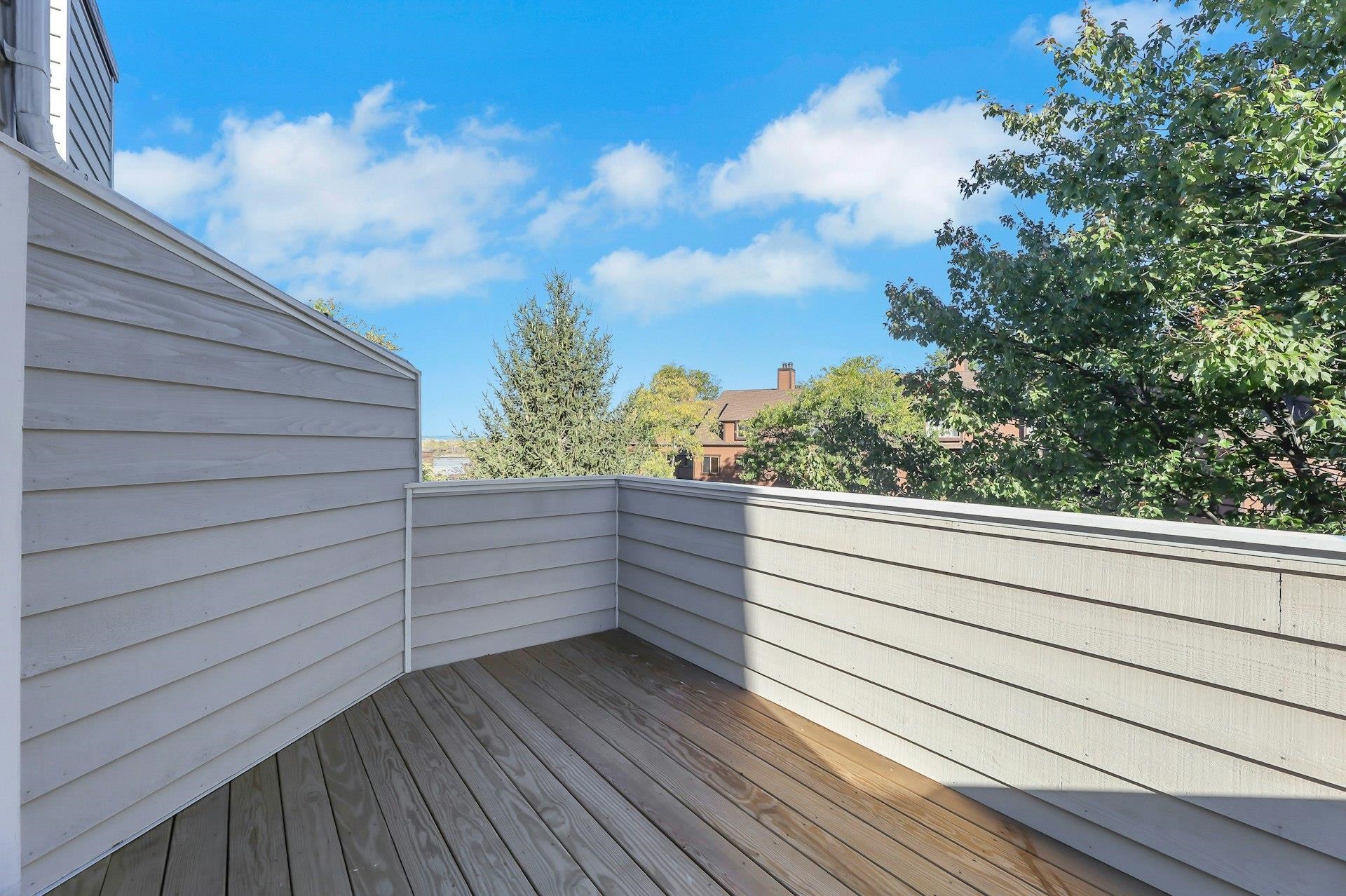 726 Mainsail Lane, Unit MAINSAIL LANE Secaucus, NJ 07094 - Photo 31 of 39 a view of a roof deck with wooden floor and fence
