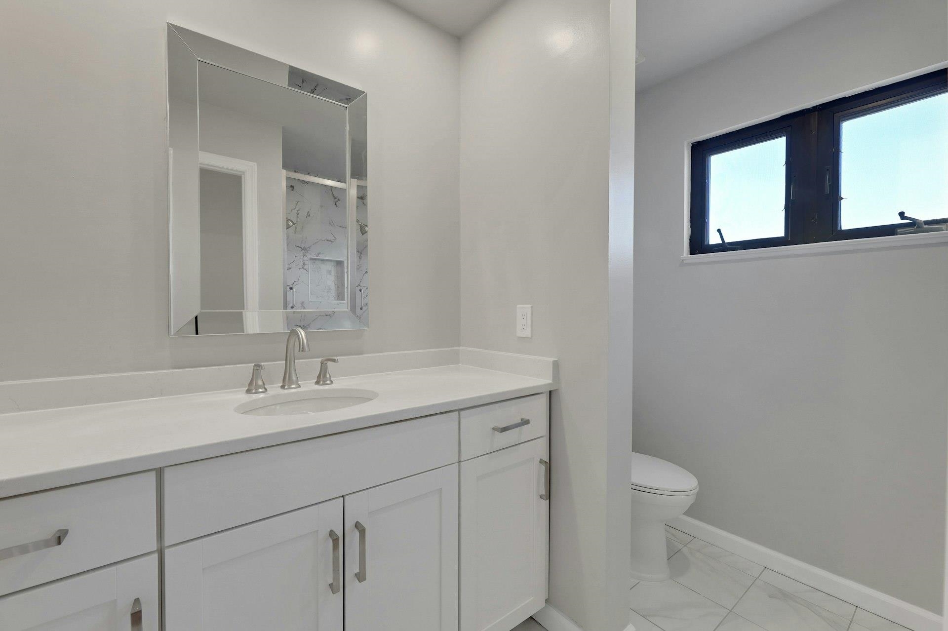 726 Mainsail Lane, Unit MAINSAIL LANE Secaucus, NJ 07094 - Photo 33 of 39 a bathroom with a toilet sink and mirror