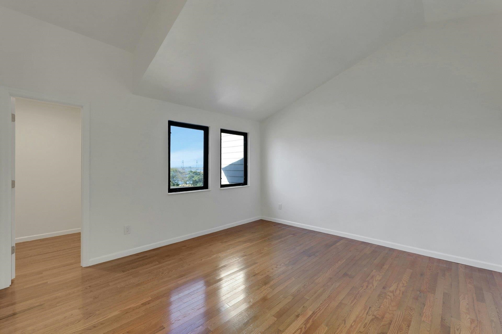 726 Mainsail Lane, Unit MAINSAIL LANE Secaucus, NJ 07094 - Photo 38 of 39 a view of an empty room with wooden floor and a window