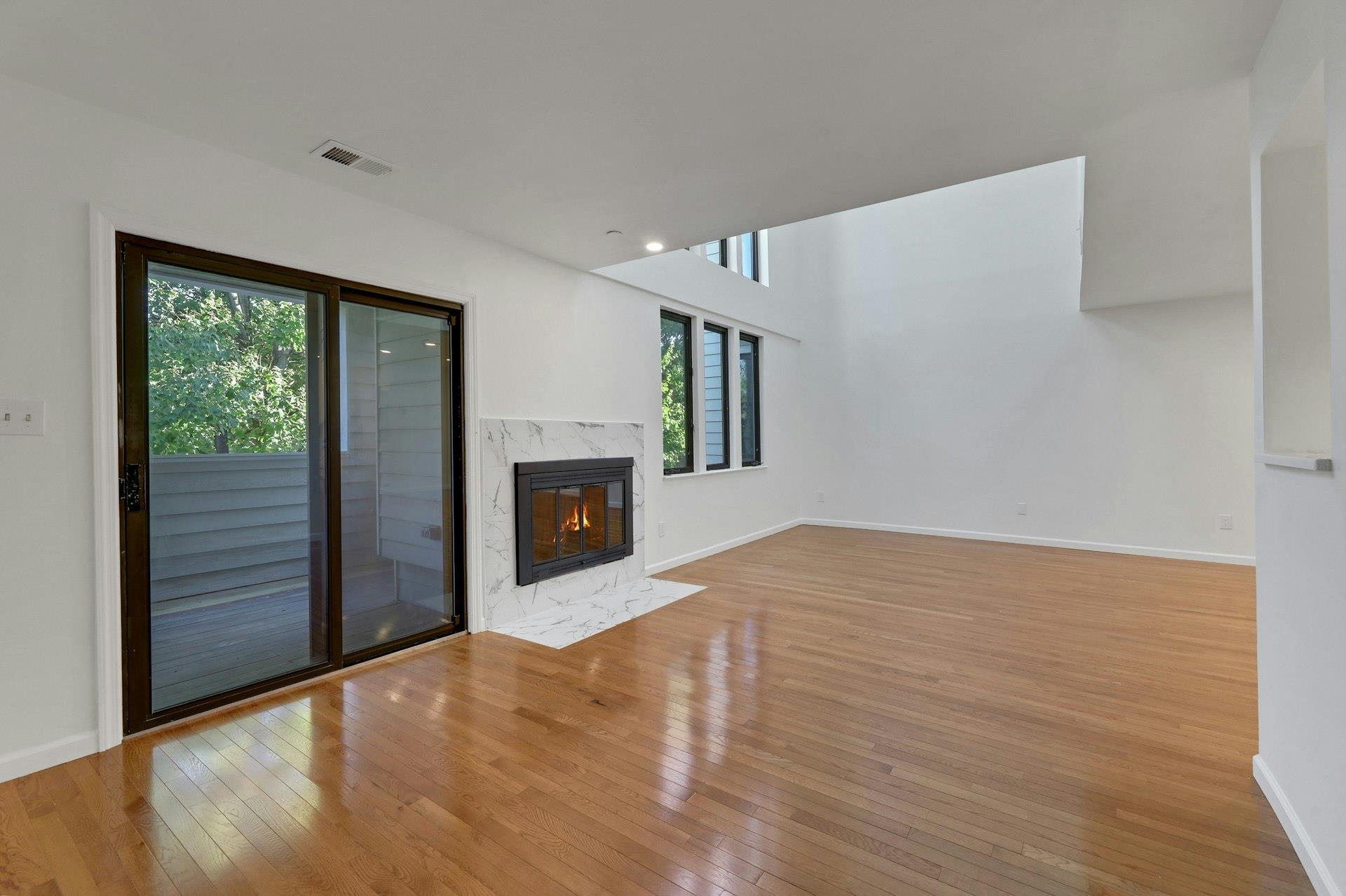 726 Mainsail Lane, Unit MAINSAIL LANE Secaucus, NJ 07094 - Photo 9 of 39 a view of empty room with wooden floor and fireplace