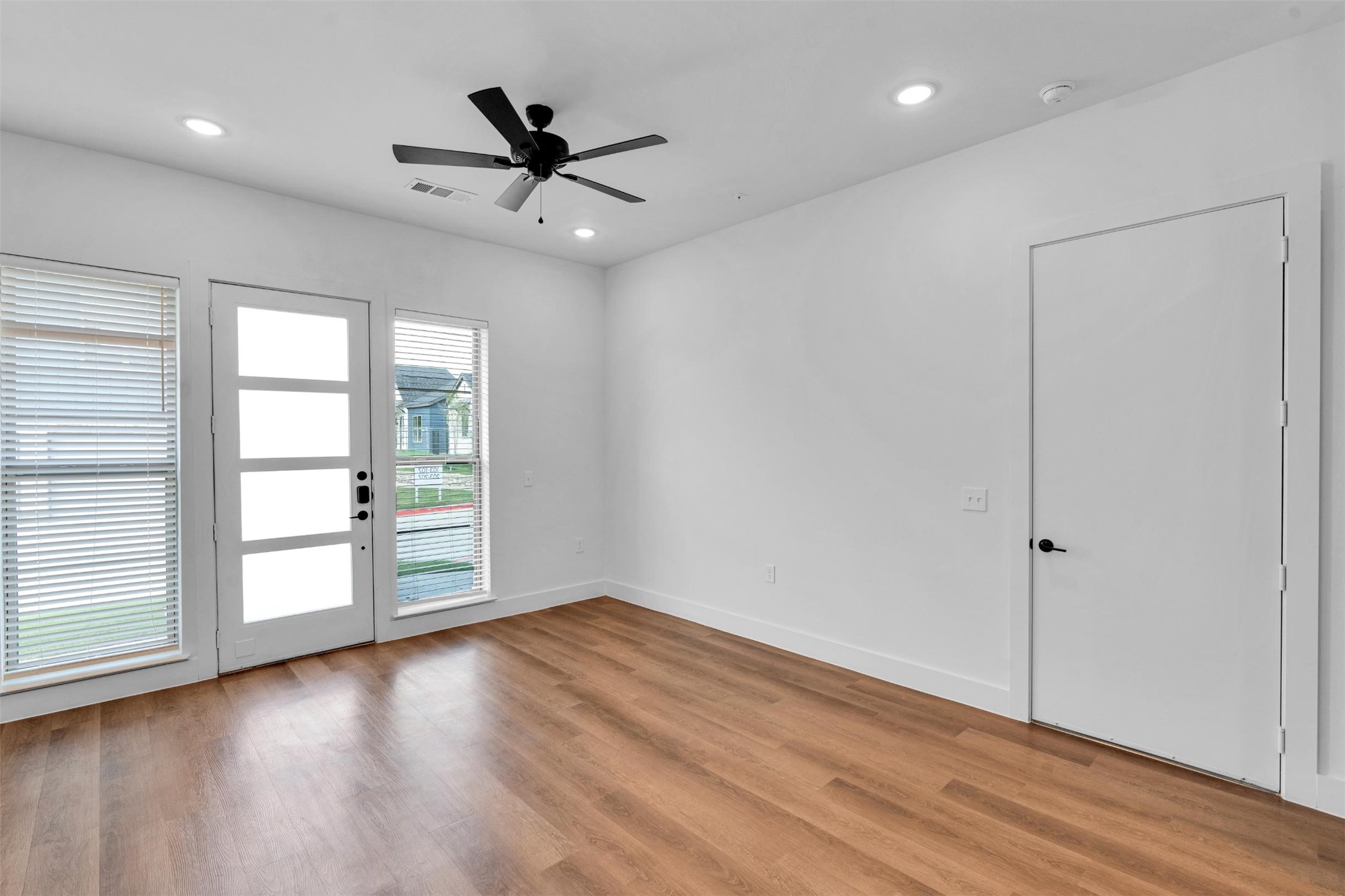 1428 A Izzy Lane Little Elm, TX 75068 - Photo 8 of 38 an empty room with wooden floor fan and windows
