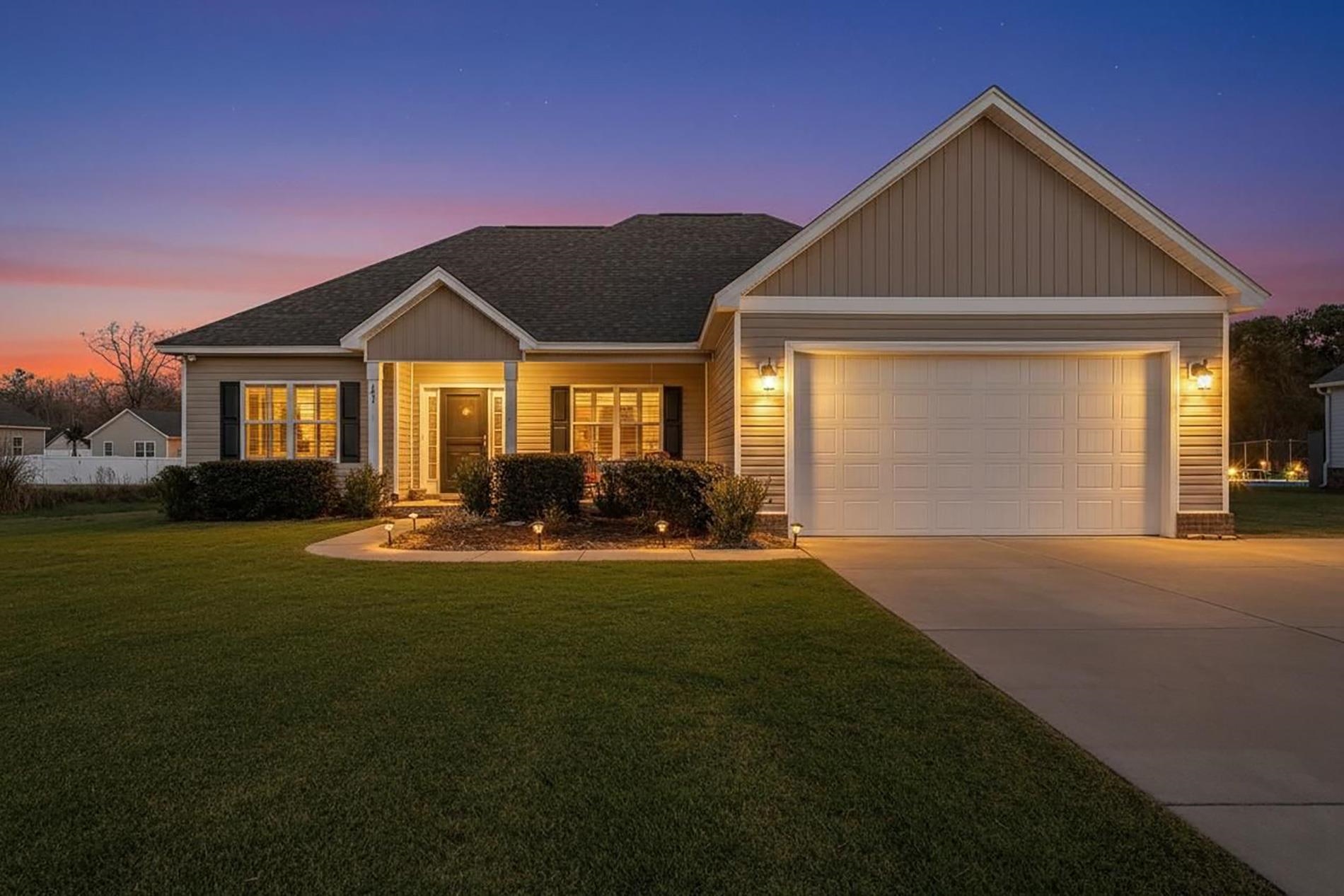 209 Highmeadow Lane Aynor, SC 29511 - Photo 3 of 4 View of front facade with a front yard, concrete driveway, and an attached garage