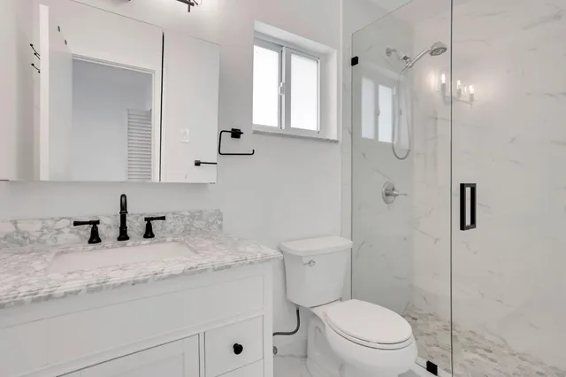 a view of a kitchen with wooden floor and a window